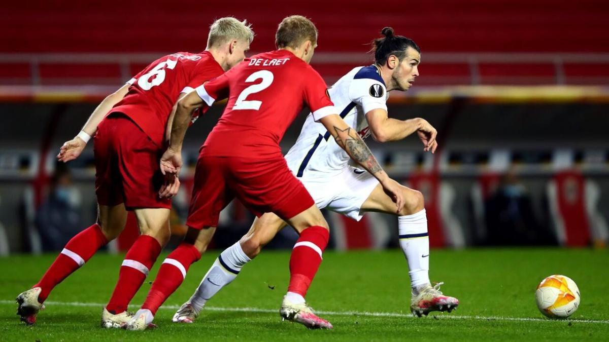 Antwerp players challenge Tottenham's Gareth Bale